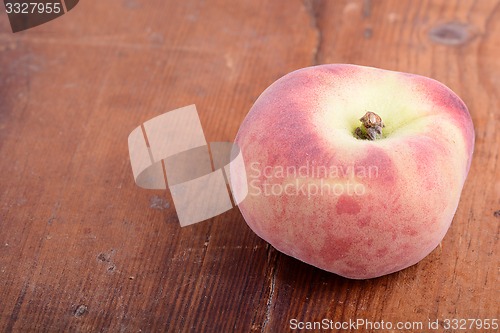 Image of Peache on wooden plate