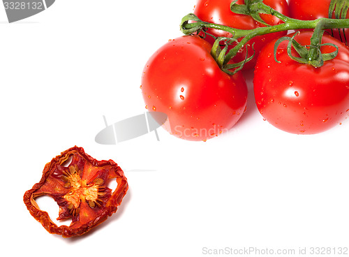 Image of Bunch of raw tomatoes with water drops and dried slice