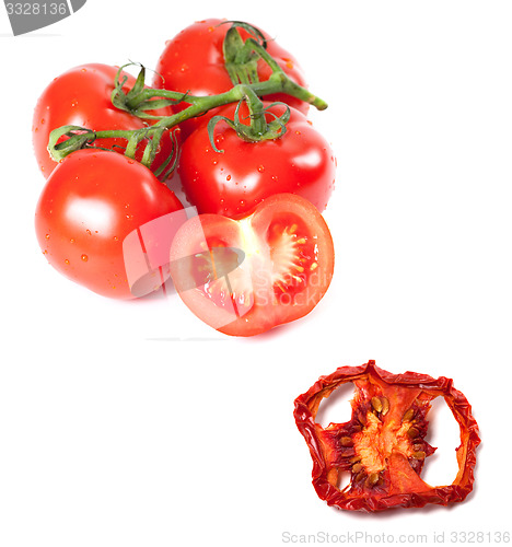 Image of Bunch of fresh tomatoes with water drops and dried slice