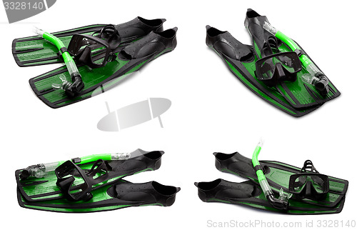 Image of Set of green swim fins, mask and snorkel for diving on white bac