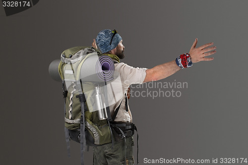 Image of back view of a male fully equipped tourist 