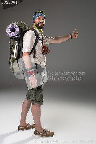 Image of Full length portrait of a male fully equipped tourist 