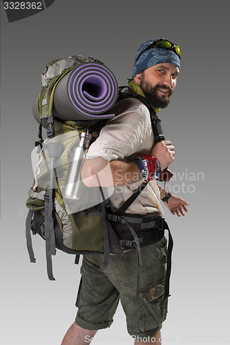 Image of back view of a male fully equipped tourist 