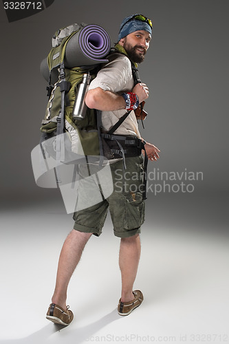 Image of Full length back view of a male fully equipped tourist 