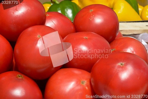 Image of red tomatoes in wooden crates