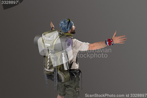 Image of back view of a male fully equipped tourist 