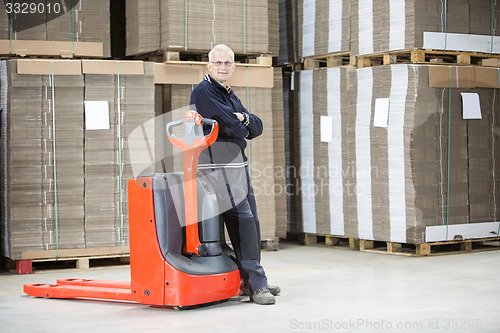 Image of Worker Standing Arms Crossed At Warehouse