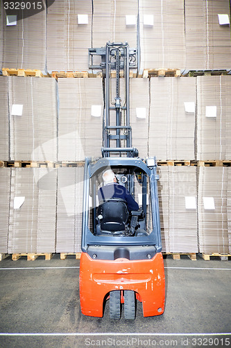 Image of Worker Examining Stock At Warehouse