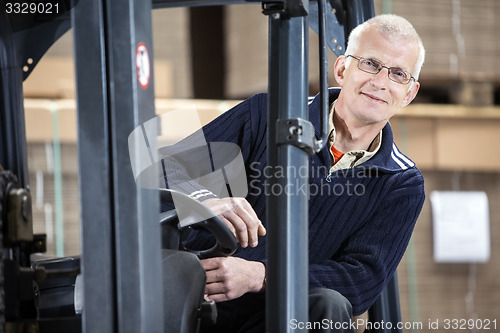 Image of Confident Worker In Forklift At Warehouse