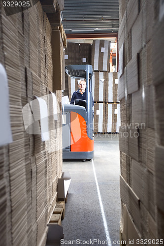 Image of Worker In Forklift Seen From Stockpiles