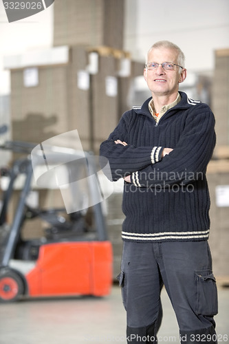 Image of Happy Worker Standing At Warehouse