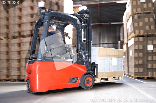 Image of Worker Carrying Stock On Forklift