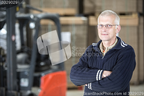 Image of Confident Worker Standing At Warehouse