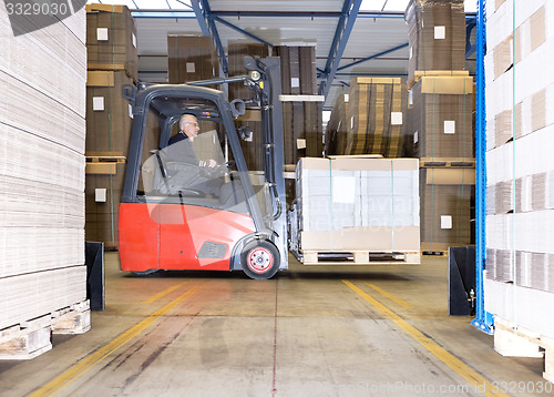 Image of Worker Carrying Goods On Forklift