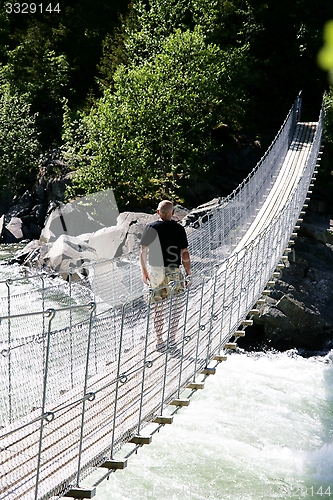 Image of Man on suspension bridge