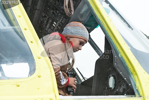 Image of Girl sits in cabin of MI-8 helicopter