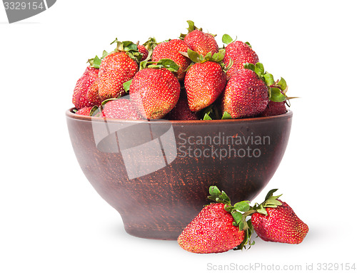 Image of Ripe juicy strawberries in a ceramic bowl and two near