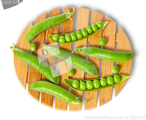 Image of Pods of peas on bamboo board top and front view