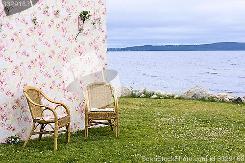 Image of Background and couple of chairs on lakeshore