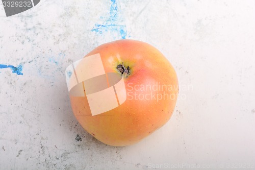 Image of apple on old white plate