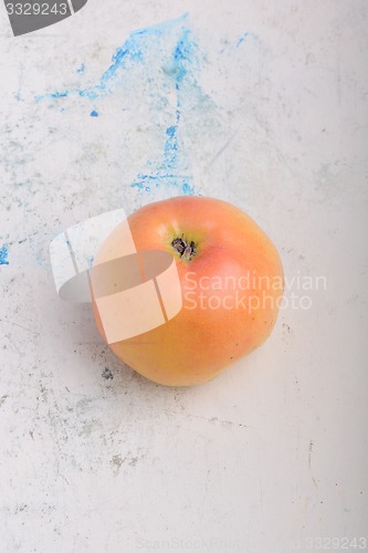 Image of apple on old white plate