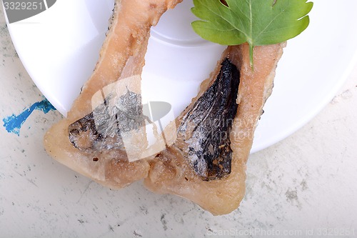 Image of Frying pan with one roasted salmon steaks, view from above