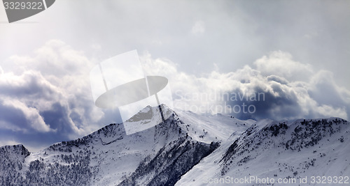 Image of Mountains in evening cloudy sky