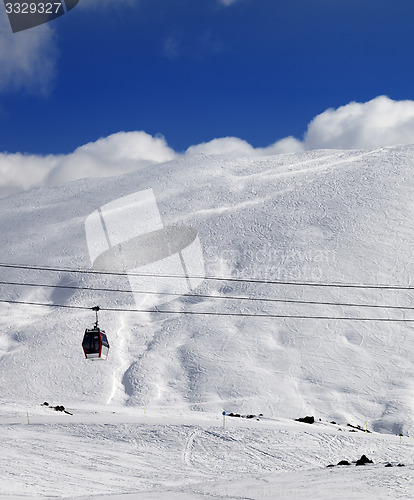 Image of Gondola lift and off-piste slope at sun day