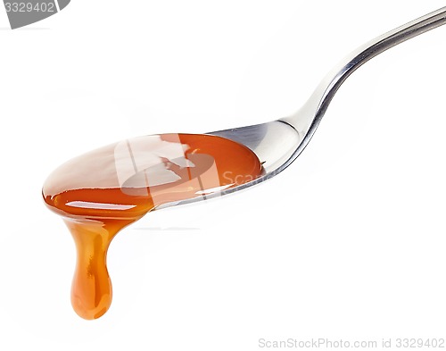 Image of spoon of caramel sauce