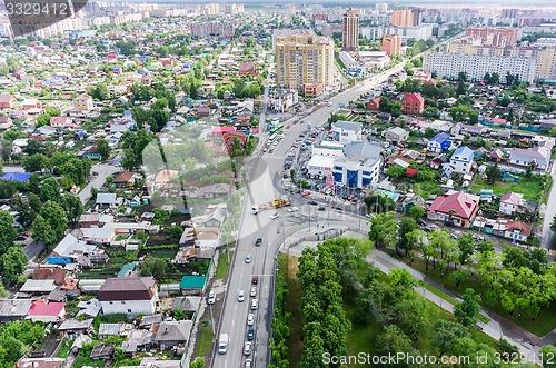 Image of Aerial city view on crossroad, carshop and houses