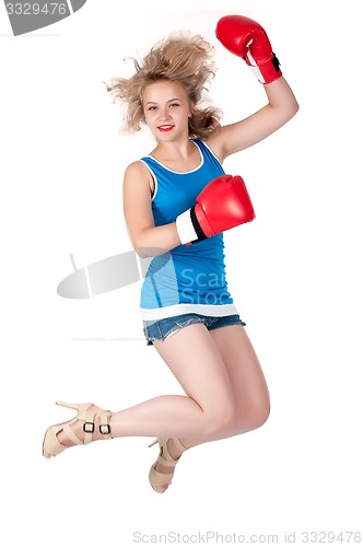 Image of Pretty girl in boxing gloves at jump