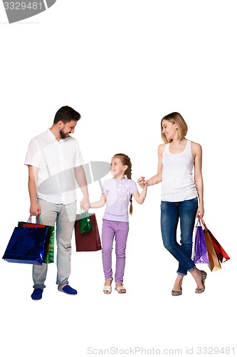 Image of Happy family with shopping bags standing at studio 
