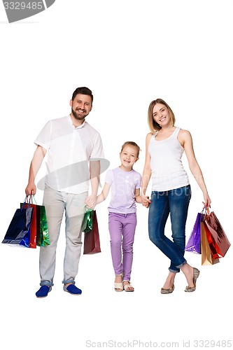 Image of Happy family with shopping bags standing at studio 