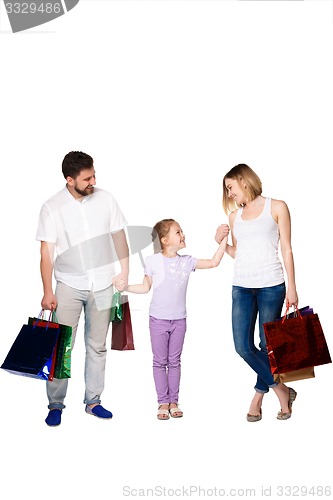 Image of Happy family with shopping bags standing at studio 