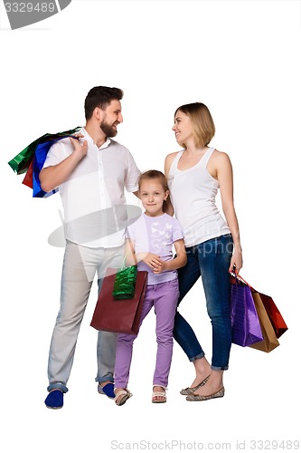 Image of Happy family with shopping bags standing at studio 