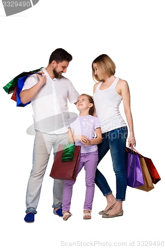 Image of Happy family with shopping bags standing at studio 