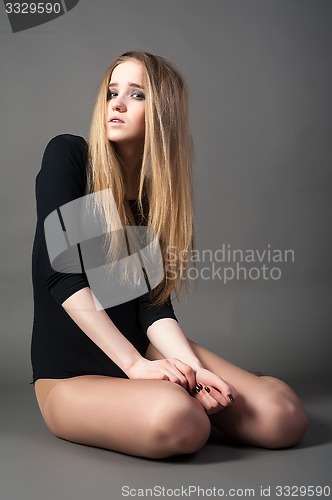 Image of Attractive sad woman in gymnastic suit