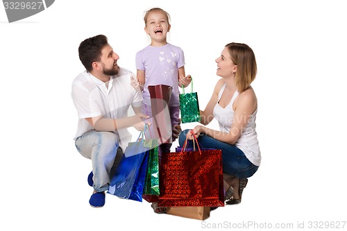 Image of Happy family with shopping bags standing at studio 