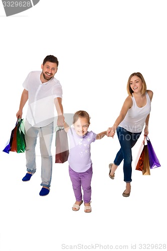 Image of Happy family with shopping bags standing at studio 