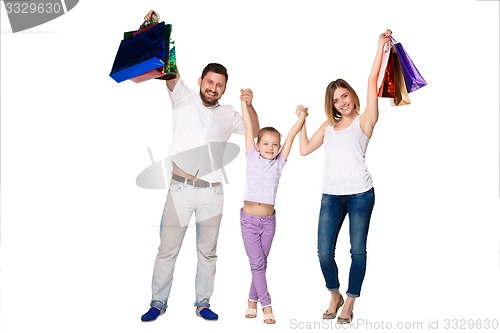 Image of Happy family with shopping bags standing at studio 