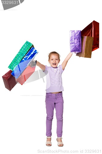 Image of Happy girl with shopping bags standing at studio 