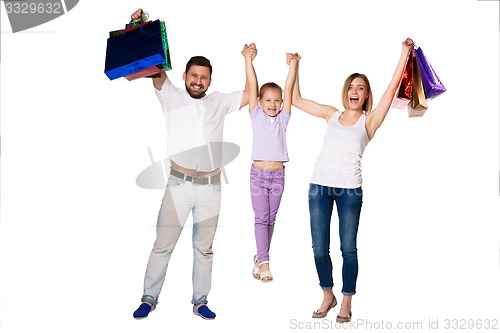 Image of Happy family with shopping bags standing at studio 