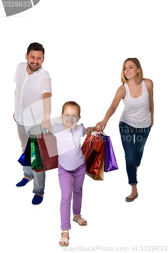 Image of Happy family with shopping bags standing at studio 