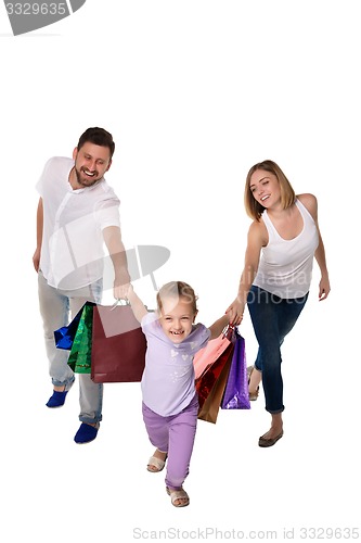 Image of Happy family with shopping bags standing at studio 