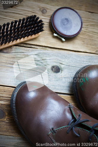 Image of boots, shoe polish and shoe brush