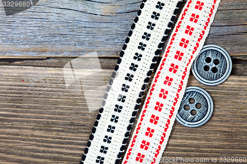 Image of antique ribbons with embroidered ornaments and old buttons