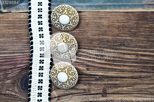 Image of Vintage ribbon with embroidered pattern and three ancient button