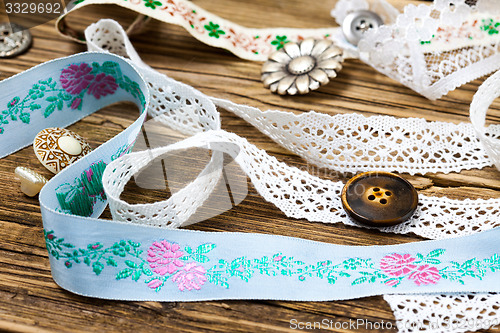 Image of ribbon, lace, ribbons and buttons