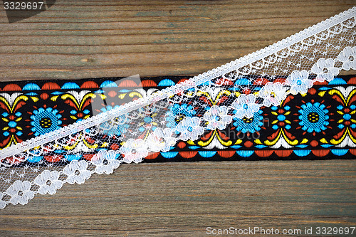 Image of vintage ribbons and lace on the aged boards