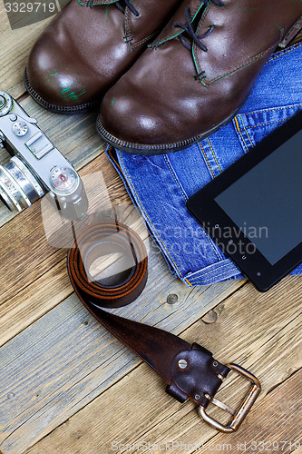 Image of traveler set with a leather belt, digitizer, camera, jeans and b